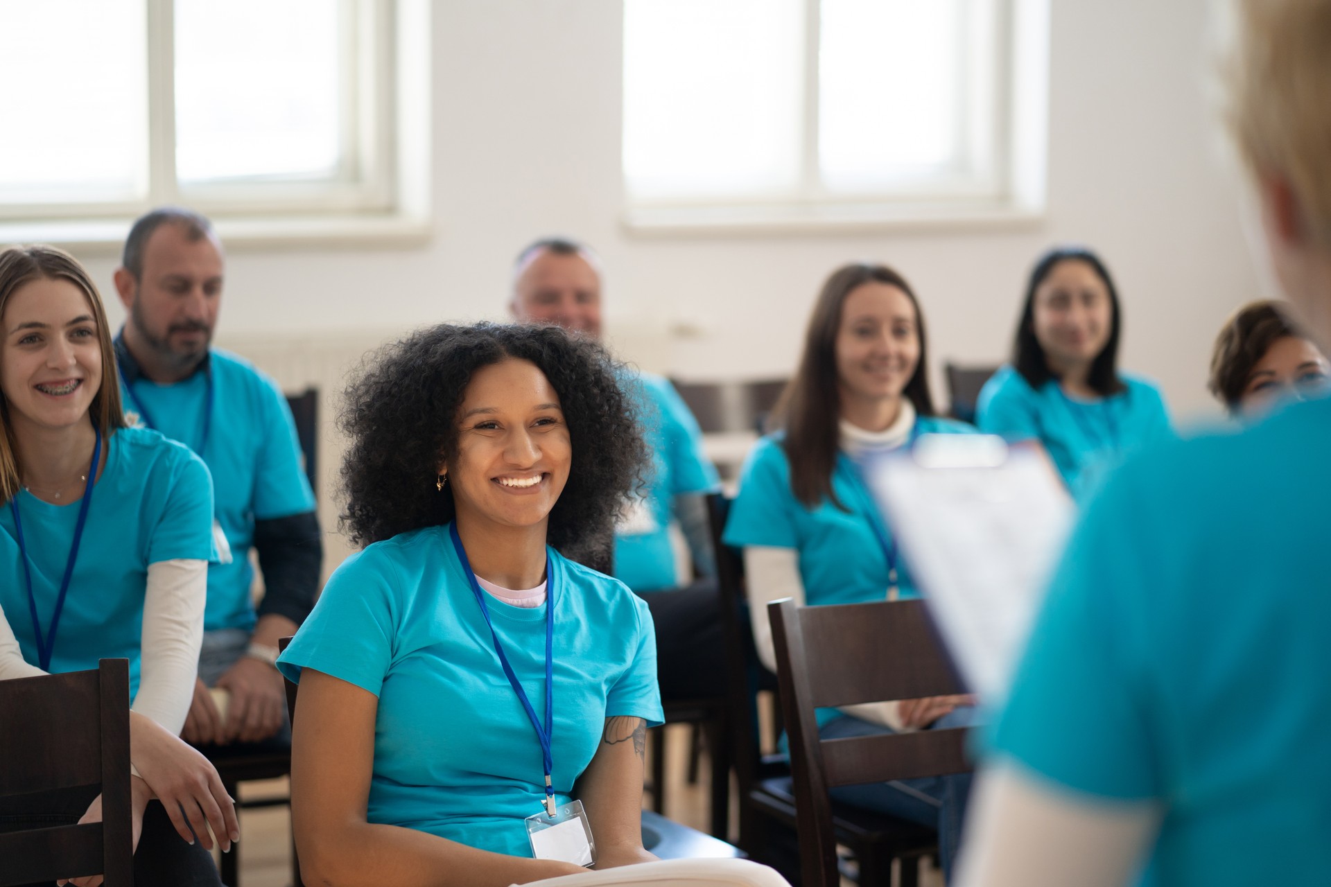 Smiling volunteers listening to a team talk